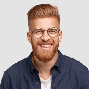 pleased cheerful redhaired male with pleasant smil CCXAYZL
